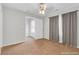 An open bedroom with gray curtains and carpet features a closet and neutral decor for a calming vibe at 5807 Mitchell Chase Trl, Mableton, GA 30126