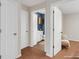 A carpeted hallway features multiple entryways with white doors, enhancing the home's appeal at 5807 Mitchell Chase Trl, Mableton, GA 30126