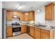 Well-lit kitchen with stainless steel appliances, granite countertops, and wooden cabinets at 5807 Mitchell Chase Trl, Mableton, GA 30126