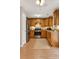 Modern kitchen with stainless steel appliances, tile flooring, wooden cabinets, and granite countertops at 5807 Mitchell Chase Trl, Mableton, GA 30126