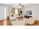 Bright living room with hardwood floors, stylish furniture, a ceiling fan, and a large window at 5807 Mitchell Chase Trl, Mableton, GA 30126