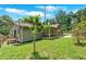 View of home exterior and large grassy backyard with a small deck and porch perfect for outdoor entertaining at 161 Old Vandiver Dr, Canton, GA 30114