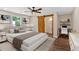 Cozy bedroom featuring a modern bed frame, ceiling fan, wood floors, and an ensuite bathroom at 161 Old Vandiver Dr, Canton, GA 30114