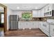 Bright kitchen featuring stainless steel appliances, granite counters, and modern cabinets at 161 Old Vandiver Dr, Canton, GA 30114