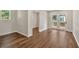 Open living area with hardwood floors and access to the back deck through the bright french doors at 161 Old Vandiver Dr, Canton, GA 30114