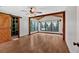 Bright main bedroom boasts hardwood floors, a ceiling fan, large windows, and a walk in closet at 161 Old Vandiver Dr, Canton, GA 30114