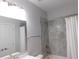 Bathroom with a white vanity and tiled shower, featuring a rain shower head at 330 La Perla Dr, Sugar Hill, GA 30518