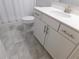 Bright bathroom featuring a sleek white vanity, modern fixtures, and tile flooring at 330 La Perla Dr, Sugar Hill, GA 30518
