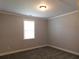 Bedroom featuring neutral walls, plush gray carpet and a bright window at 330 La Perla Dr, Sugar Hill, GA 30518
