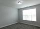 Neutral bedroom with a window offering natural light and soft carpeting at 330 La Perla Dr, Sugar Hill, GA 30518