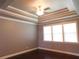Bright bedroom with tray ceiling, ceiling fan, and natural light at 330 La Perla Dr, Sugar Hill, GA 30518