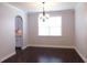 Dining room with hanging light fixture above the table, a large window, and dark hardwood floors at 330 La Perla Dr, Sugar Hill, GA 30518