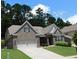 Beautiful brick home with well-manicured lawn and mature trees at 330 La Perla Dr, Sugar Hill, GA 30518
