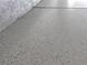 Epoxy coated garage floor in gray with blue, black, and white decorative flakes at 330 La Perla Dr, Sugar Hill, GA 30518