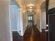 Hallway with hardwood floors and white trim archways leading to the rest of the home at 330 La Perla Dr, Sugar Hill, GA 30518