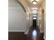Inviting hallway featuring hardwood floors, archways, and stylish lighting fixtures at 330 La Perla Dr, Sugar Hill, GA 30518
