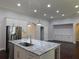 Bright kitchen features granite countertops, stainless steel appliances, and island with sink at 330 La Perla Dr, Sugar Hill, GA 30518