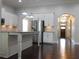 Modern kitchen features granite countertops, stainless steel appliances, and dark hardwood floors at 330 La Perla Dr, Sugar Hill, GA 30518