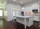 Bright kitchen island with stainless steel appliances and adjacent backyard access at 330 La Perla Dr, Sugar Hill, GA 30518