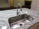 Kitchen island featuring a stainless steel sink and a granite countertop at 330 La Perla Dr, Sugar Hill, GA 30518