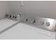 Modern laundry area featuring white Maytag appliances at 330 La Perla Dr, Sugar Hill, GA 30518