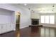 Spacious living room with stone fireplace, hardwood floors, and natural light at 330 La Perla Dr, Sugar Hill, GA 30518