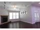 Open living room with stone fireplace, recessed lighting and three windows at 330 La Perla Dr, Sugar Hill, GA 30518