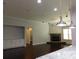 Open floorplan living room featuring a granite counter top, a stone fireplace and custom built-in shelving at 330 La Perla Dr, Sugar Hill, GA 30518