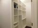 A white, spacious pantry showcases ample storage with its many adjustable shelves and modern design at 330 La Perla Dr, Sugar Hill, GA 30518