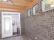 Covered patio features brick walls, tile flooring, and a view into the kitchen with stainless steel appliances at 330 La Perla Dr, Sugar Hill, GA 30518