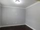 Neutral room with dark hardwood floors, white trim and modern lighting at 330 La Perla Dr, Sugar Hill, GA 30518