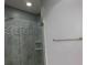 Modern shower featuring elegant tilework, rainfall showerhead, and a glass door at 330 La Perla Dr, Sugar Hill, GA 30518