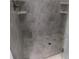 A tiled walk-in shower with a drain, providing a clean and modern look at 330 La Perla Dr, Sugar Hill, GA 30518