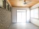 Light-filled sunroom with brick wall, wood ceiling, and sliding glass doors at 330 La Perla Dr, Sugar Hill, GA 30518