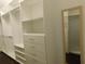 A well-organized walk-in closet with multiple shelves, drawers, and a full-length mirror at 330 La Perla Dr, Sugar Hill, GA 30518