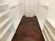 Walk-in closet showcasing shelving and hardwood floors, offering ample room for organization at 330 La Perla Dr, Sugar Hill, GA 30518