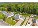 Aerial view of home with large yard, mature trees, and long driveway, with lush surrounding landscape at 1320 Pinyon Pl, Lawrenceville, GA 30043