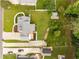 Bird's eye view of home showcasing deck, lush landscaping, backyard, long driveway, and mature trees at 1320 Pinyon Pl, Lawrenceville, GA 30043