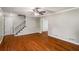 Inviting living room with hardwood floors, a staircase, neutral paint, and a ceiling fan, creating a cozy atmosphere at 1320 Pinyon Pl, Lawrenceville, GA 30043