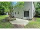 The backyard of the house features a concrete patio and lush greenery surrounding the property at 1534 Sw Austin Sw Rd, Atlanta, GA 30331