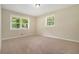 Comfortable carpeted bedroom featuring two windows, with abundant natural light, and neutral walls at 1534 Sw Austin Sw Rd, Atlanta, GA 30331