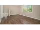 Bedroom with a window and wood-look flooring, adjacent to stairwell at 1534 Sw Austin Sw Rd, Atlanta, GA 30331