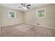 Comfortable bedroom featuring neutral paint, plush carpet, and abundant natural light from two windows at 1534 Sw Austin Sw Rd, Atlanta, GA 30331