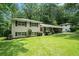 Beautiful exterior view of a split-level home with a red front door and landscaped front yard at 1534 Sw Austin Sw Rd, Atlanta, GA 30331