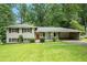Charming split-level home with brick facade, manicured lawn, and covered carport nestled in lush greenery at 1534 Sw Austin Sw Rd, Atlanta, GA 30331