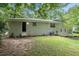 The exterior of the home features a white brick facade with a door, window, and sprawling lawn at 1534 Sw Austin Sw Rd, Atlanta, GA 30331