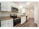 Modern kitchen with stainless steel appliances, granite countertops, and white cabinets at 1534 Sw Austin Sw Rd, Atlanta, GA 30331