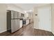 Updated kitchen featuring stainless steel appliances, white cabinetry and wood-look flooring at 1534 Sw Austin Sw Rd, Atlanta, GA 30331