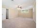 Open-concept living room featuring neutral paint, plush carpet, and an abundance of natural light at 1534 Sw Austin Sw Rd, Atlanta, GA 30331