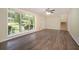 Bright living room featuring wood floors, large window, and stairway access at 1534 Sw Austin Sw Rd, Atlanta, GA 30331